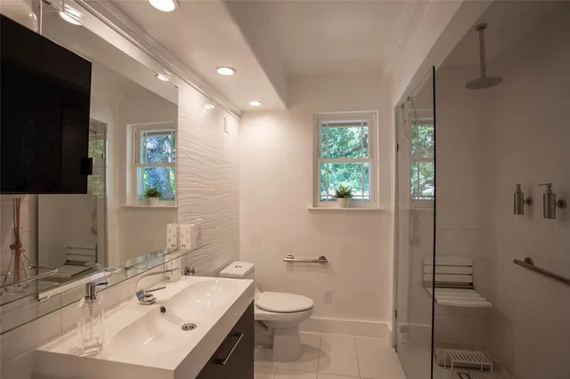 a bathroom with a sink toilet and shower