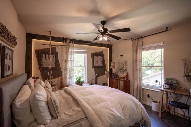 a bed sitting in a bedroom next to a window
