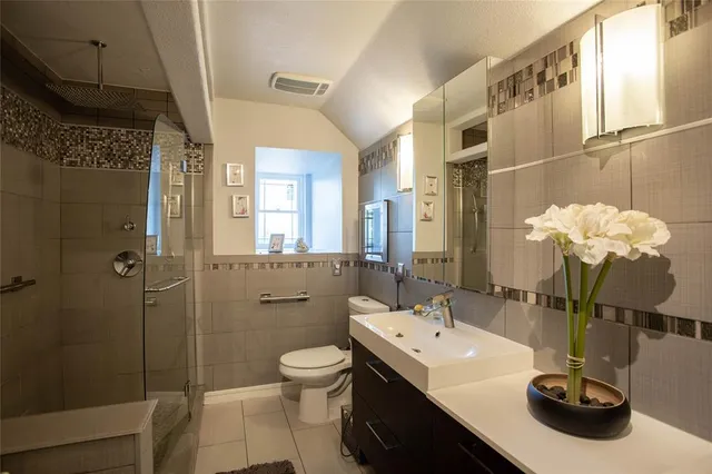 a bathroom with a sink toilet and shower