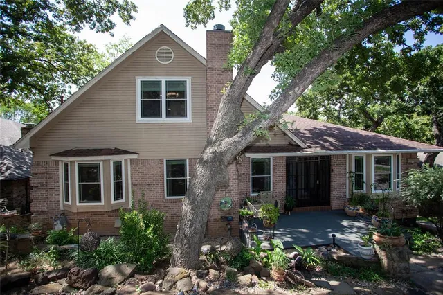 a house that has a tree in front of the house