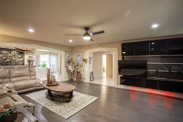 a living room with furniture and a ceiling fan