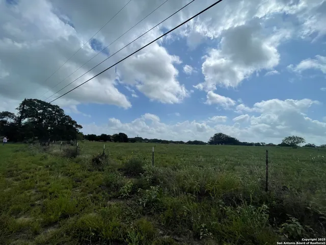a view of a big yard with a house in the background