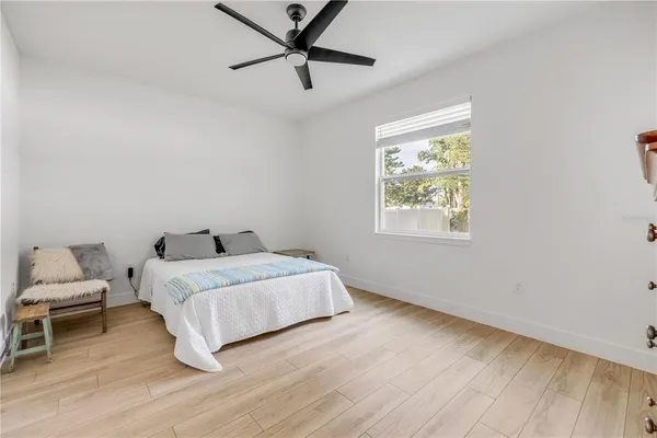 a bedroom with a bed and a window