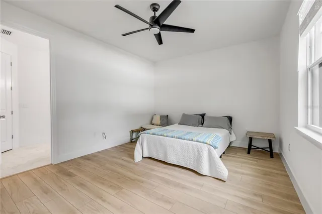 a spacious bedroom with a bed and a window