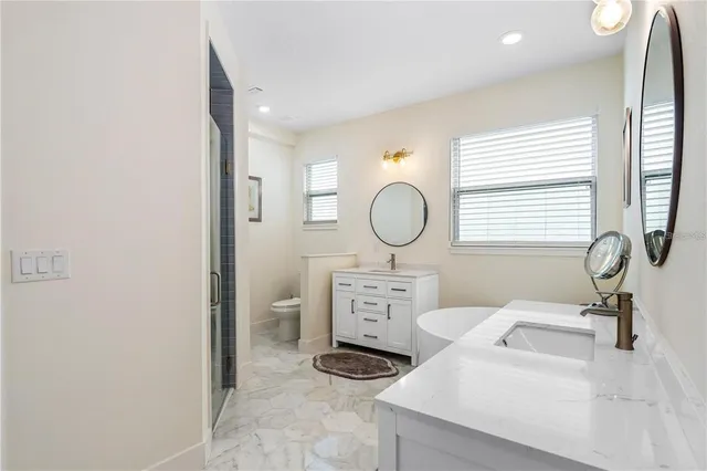 a living room with furniture a window and a potted plant