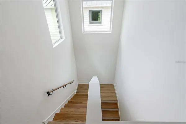 a view of a balcony with wooden floor and white walls