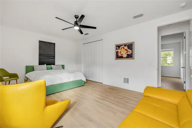 a bedroom with a bed and wooden floor