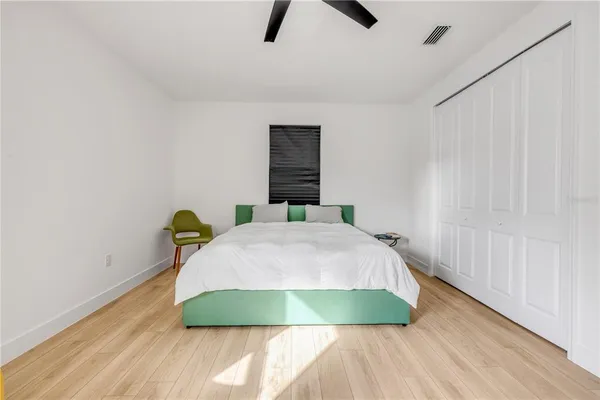 a bedroom with a bed and a window