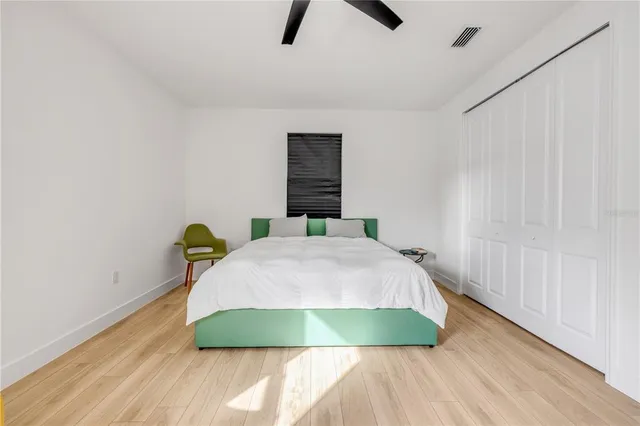 a bedroom with a bed and a window