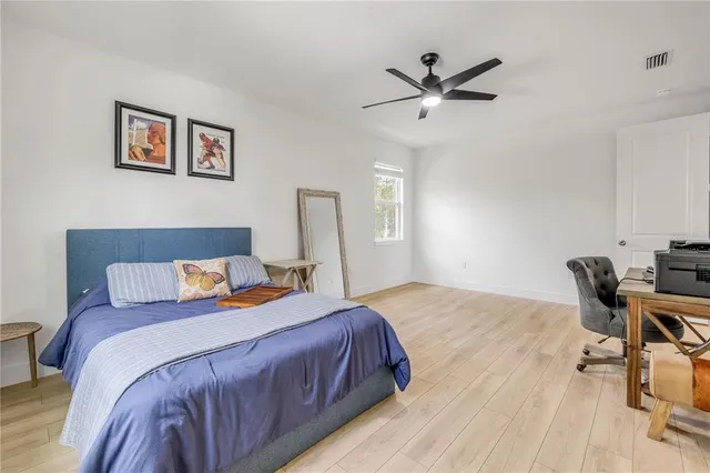 a bedroom with bed and a table