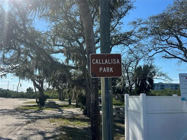 a street sign on a sidewalk next to a road