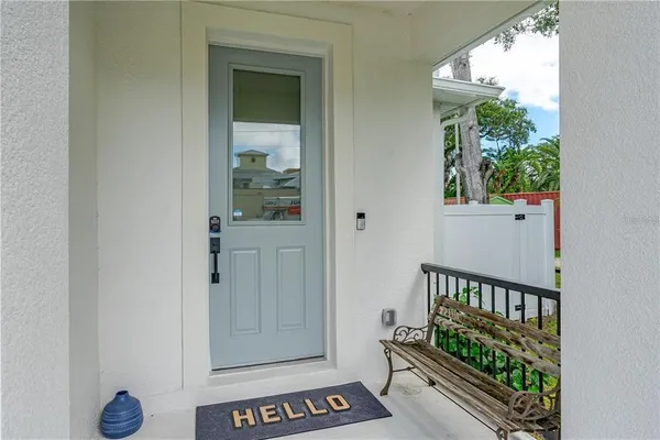 a view of a hallway with wooden floor and entryway