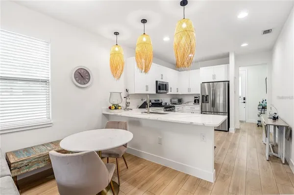 a bathroom with a sink a mirror a toilet and a window