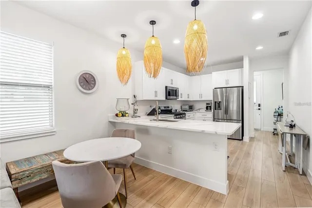 a bathroom with a sink a mirror a toilet and a window