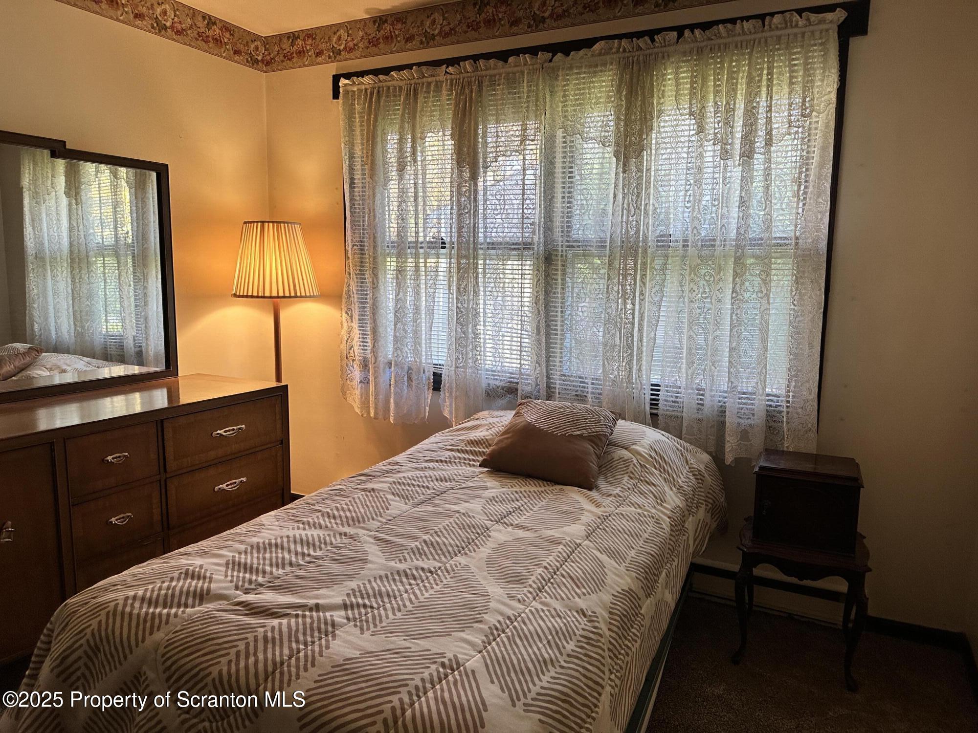 55 Yorktown Road Mountain Top, PA 18707 - Photo 19 of 32 a bedroom with a bed dresser and a window