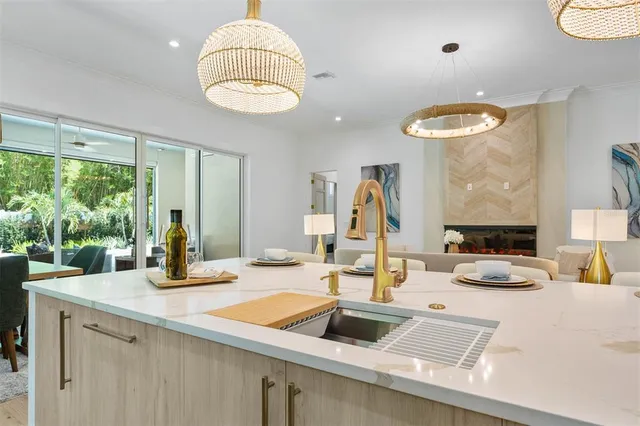 a bedroom with a bed potted plant with the dresser and mirror