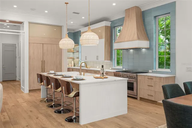 a view of a kitchen with a refrigerator and a wooden floor