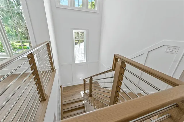 a living room with patio furniture and a floor to ceiling window