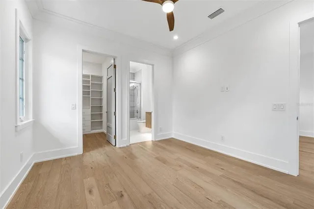 a view of a patio with table and chairs and a large tree