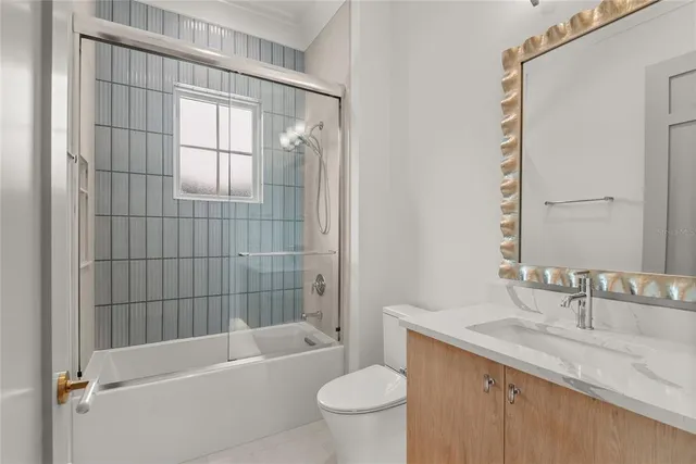 a view of a yard with plants and a large tree