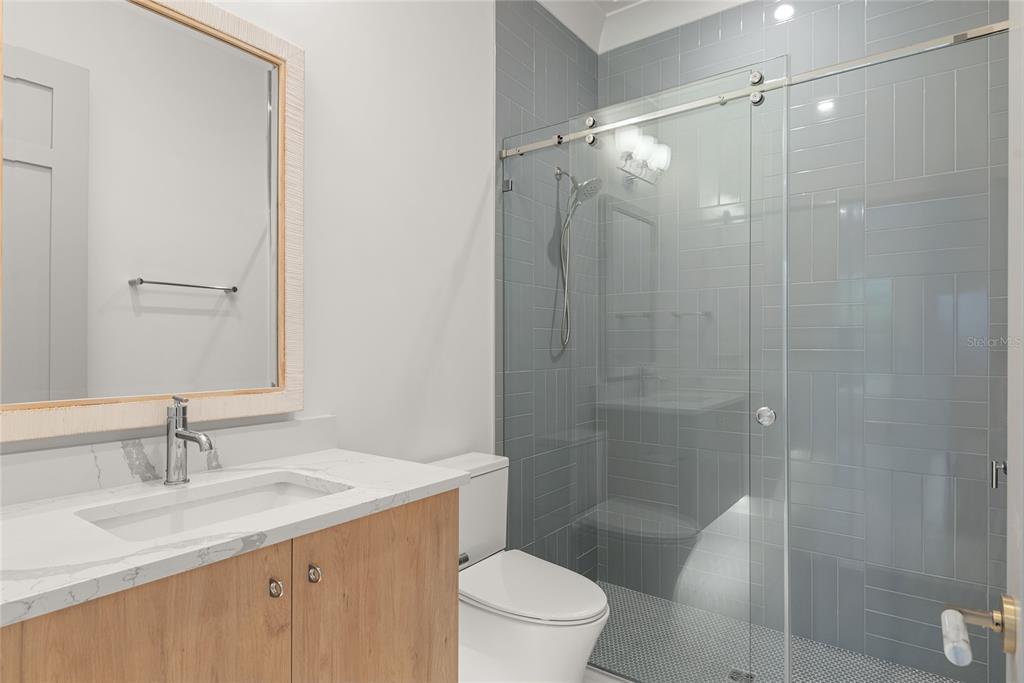 1820 Glencoe Road Winter Park, FL 32789 - Photo 43 of 75 a bathroom with a sink toilet vanity and shower