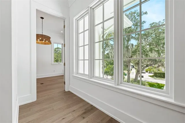 a front view of a house with a yard and trees