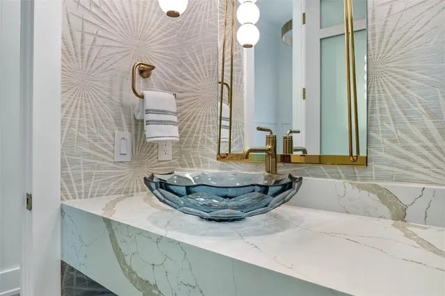 a bathroom with a sink a toilet a mirror and shower