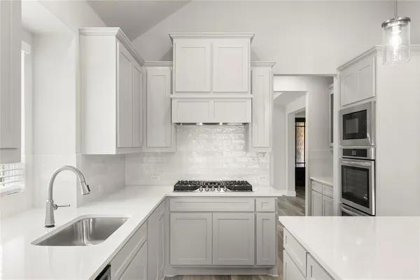 a kitchen with a sink stove and refrigerator