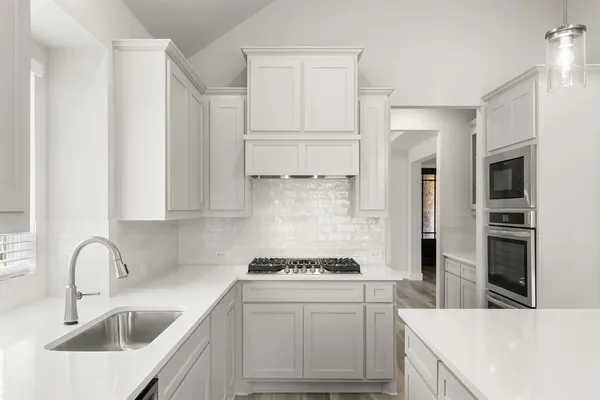 a kitchen with a sink stove and refrigerator