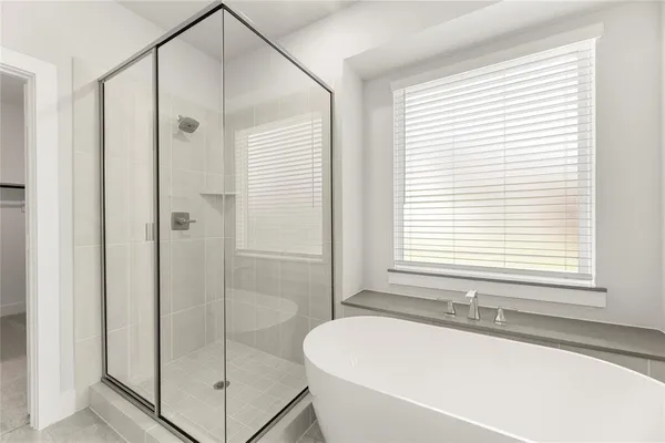 a white bath tub sitting next to a shower