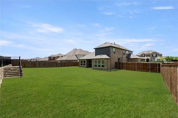 a view of a house with a yard and sitting area