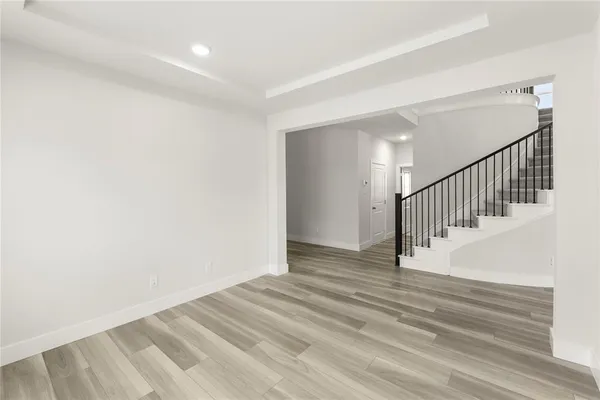 a view of a hallway with wooden floor and entryway