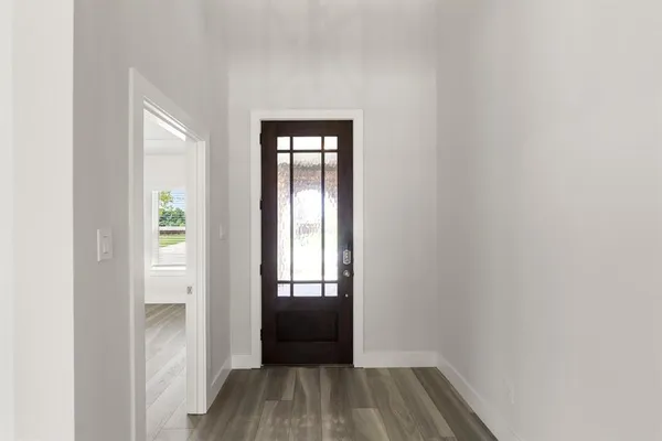a view of empty room with wooden floor