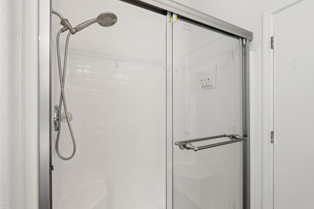13125 Alpine Drive, Unit 212 Poway, CA 92064 - Photo 14 of 22 a bathroom with a glass shower door
