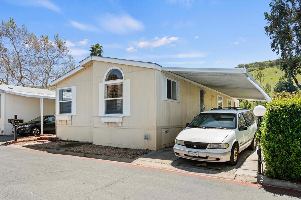 13125 Alpine Drive, Unit 212 Poway, CA 92064 - Photo 21 of 22 a car parked in front of a house