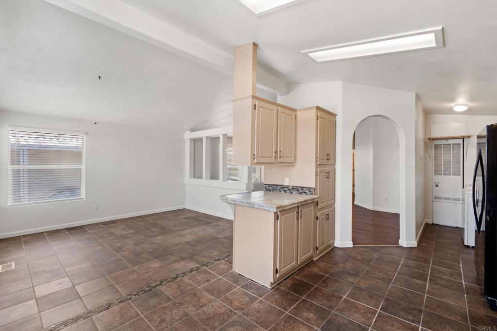 13125 Alpine Drive, Unit 212 Poway, CA 92064 - Photo 4 of 22 a kitchen with granite countertop a sink a stove a refrigerator and cabinets