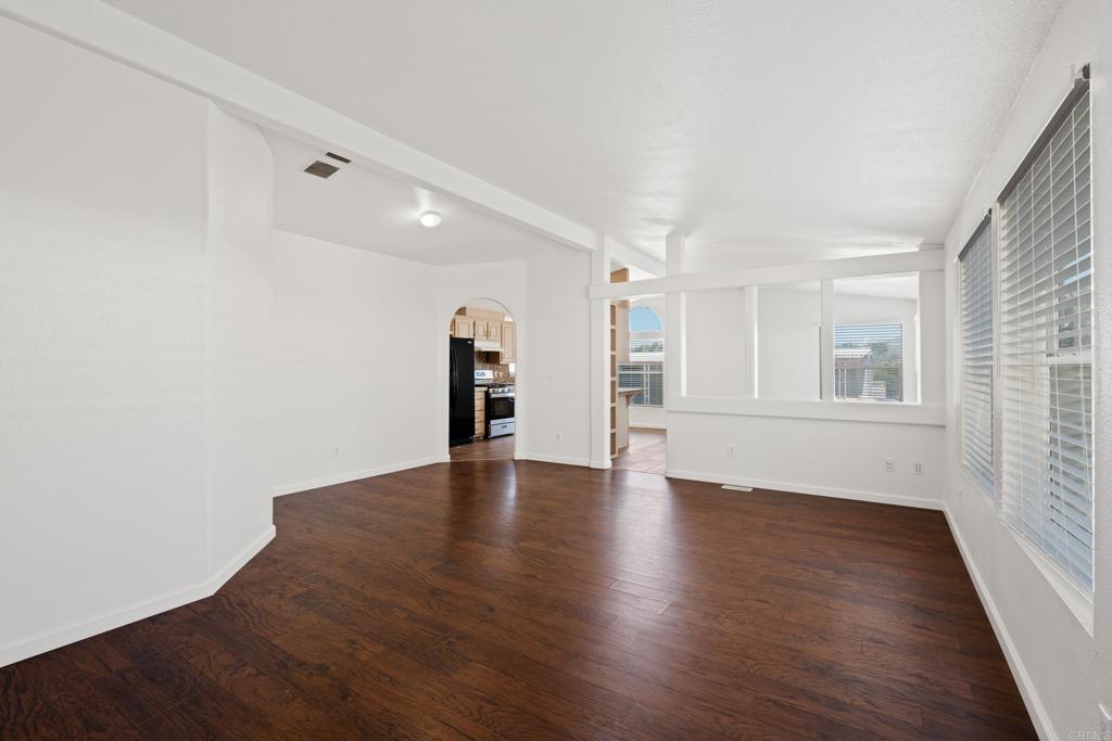 13125 Alpine Drive, Unit 212 Poway, CA 92064 - Photo 10 of 22 an empty room with wooden floor and windows