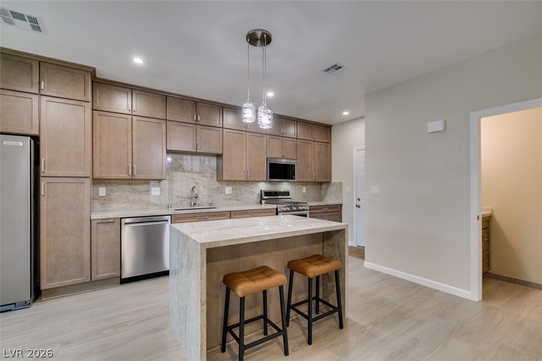 540 Sutters Mill Road Henderson, NV 89014 - Photo 27 of 46 This kitchen showcases ample cabinet space, a functional island, and contemporary appliances.