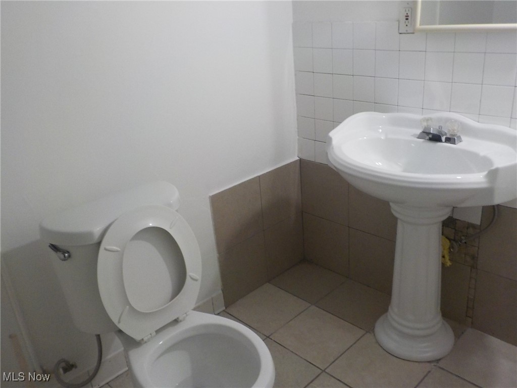 4031 Ardmore Road Cleveland, OH 44121 - Photo 19 of 19 Bathroom with toilet, tile patterned floors, and tile walls