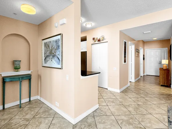 a view of front door with two painting on the wall