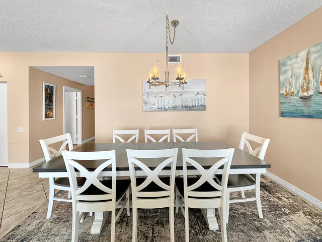 a view of a hallway with wooden floor and cabinet