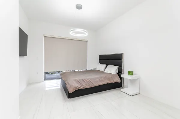 a bedroom with a bed and a mirror