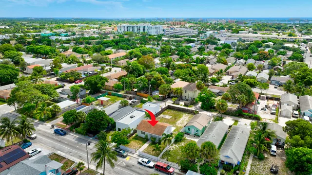 an aerial view of residential houses with outdoor space and street view