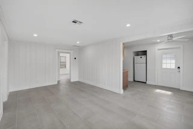 an empty room with closet and windows