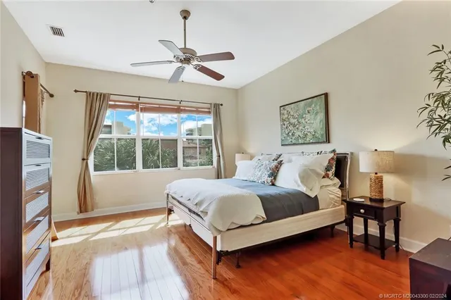 a spacious bedroom with a bed and a large window