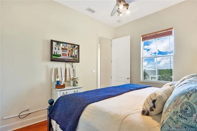 a bedroom with a bed and a window