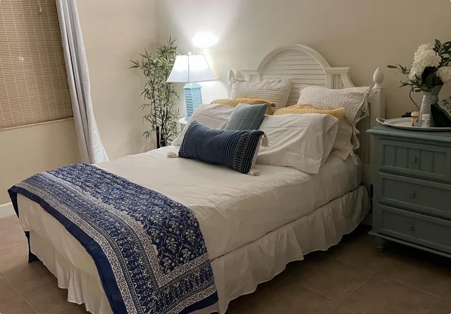 a bedroom with bed and window