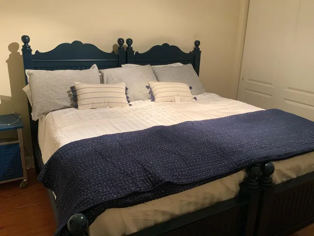 a bedroom with a bed and lamp