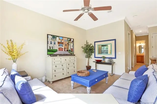 a living room with furniture and a painting on the wall