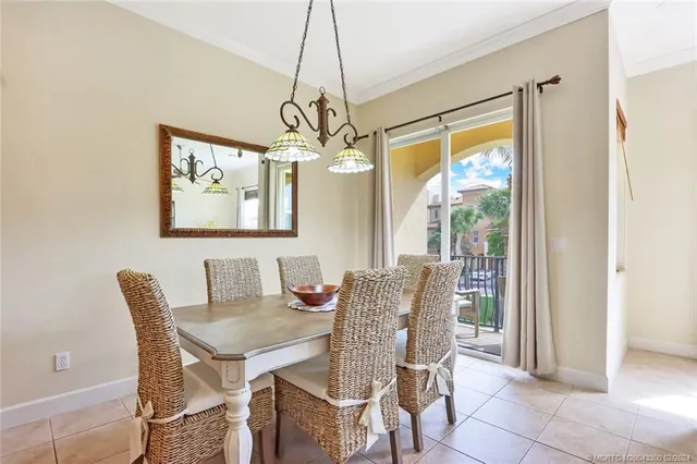 a dining room with furniture a chandelier and wooden floor